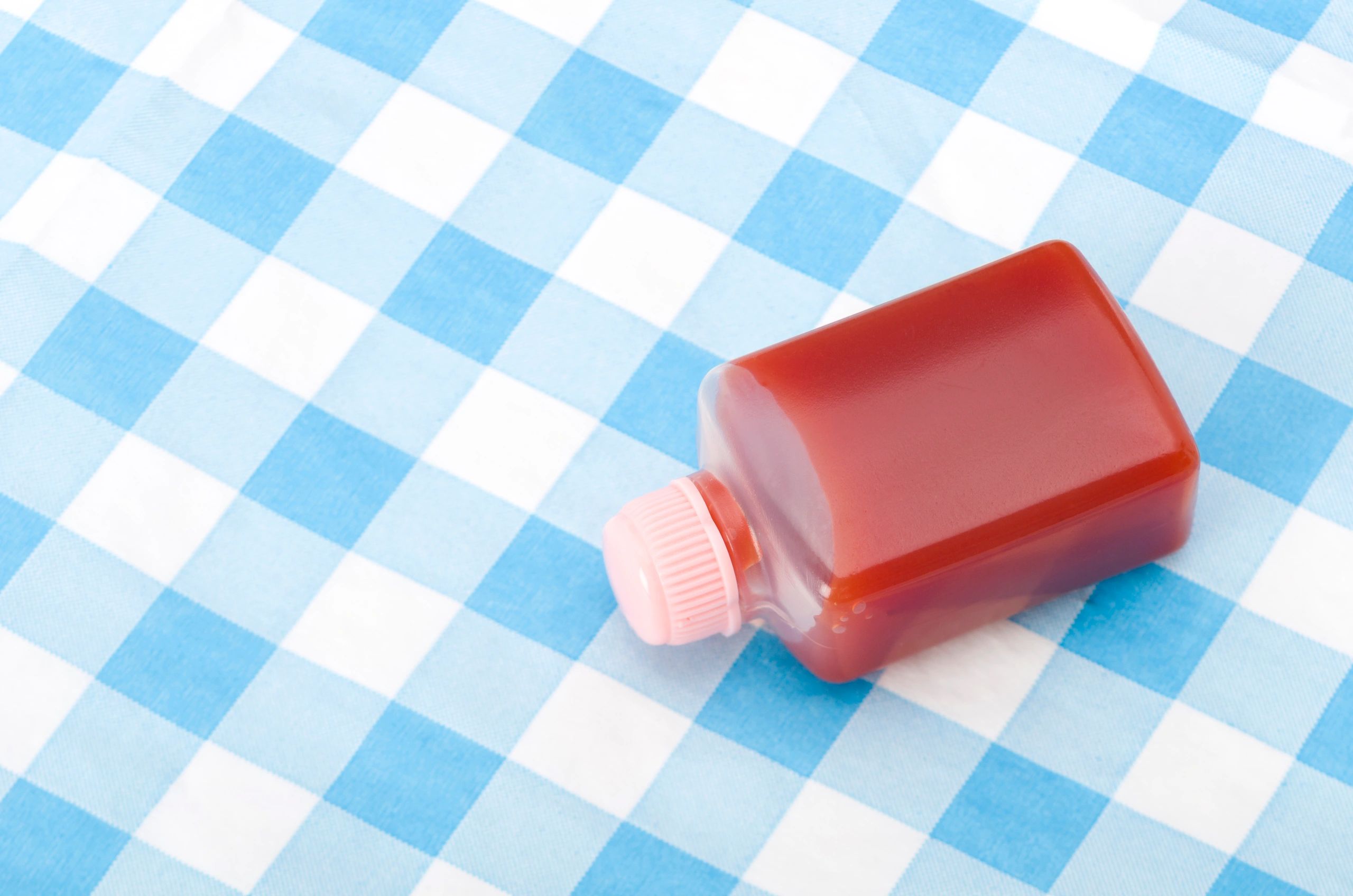 Small sauce bottle on a light background